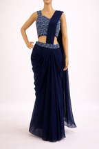 Navy blue saree with intricate blouse design on a white background