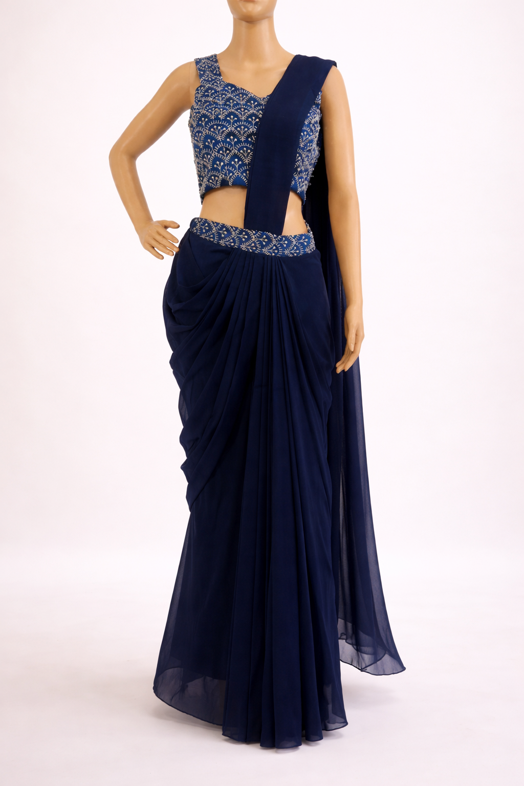 Navy blue saree with intricate blouse design on a white background