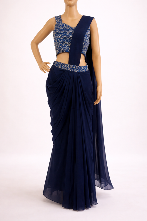 Navy blue saree with intricate blouse design on a white background